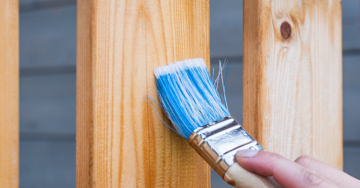 How to apply oil when seasoning wood cutting board? - Person Holding Paintbrush