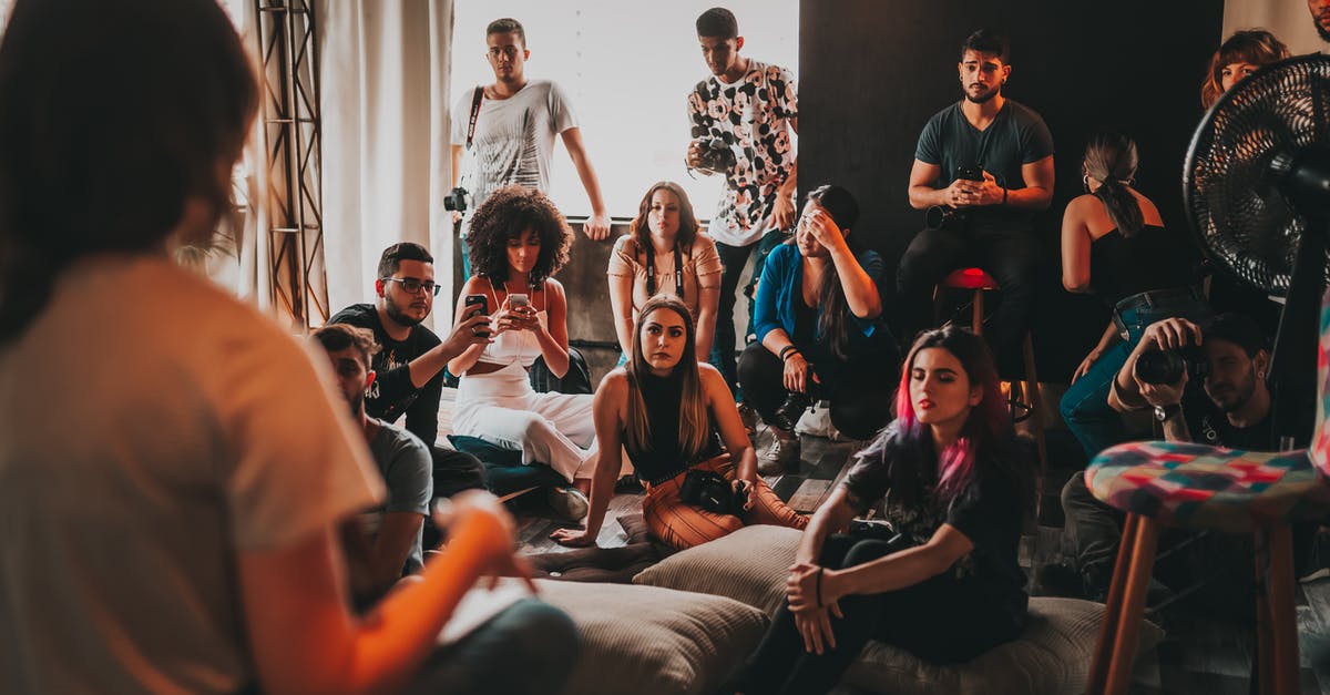 How to assemble a springform pan? - Group of multiethnic people gathering around female speaker in studio