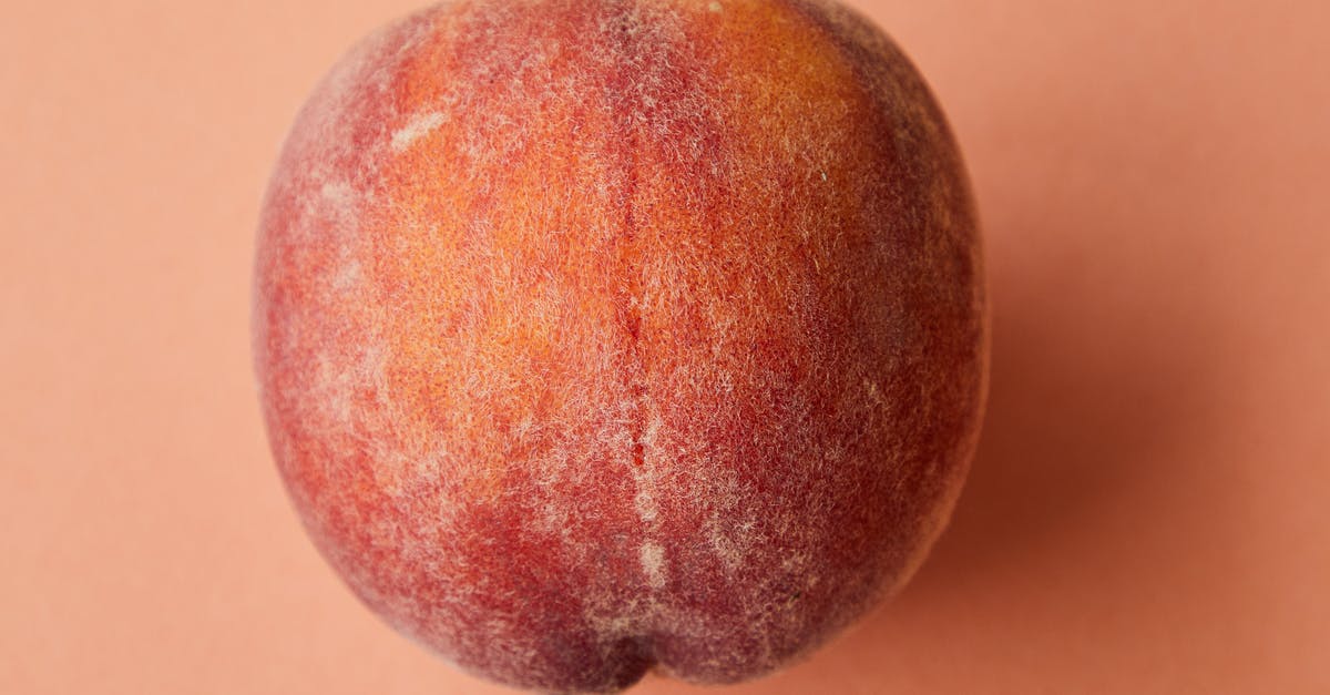 How to avoid 'fake tasting' fruit - Fresh juicy pink peach on pink surface
