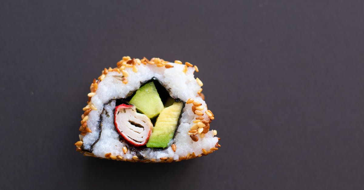 How to avoid avocado in sushi rolls from darkening? - A Single Piece of Sushi on a Black Surface