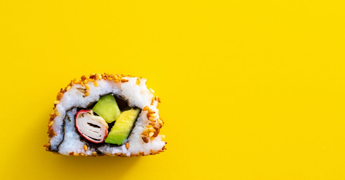 How to avoid avocado in sushi rolls from darkening? - A Single Piece of Sushi on a Yellow Surface