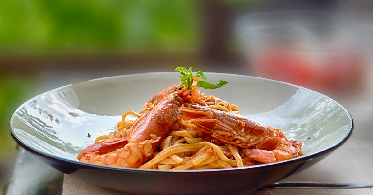 How to avoid cooked pasta soaking up sauce when stored? - Close-Up Photography of Cooked Shrimps and Pasta