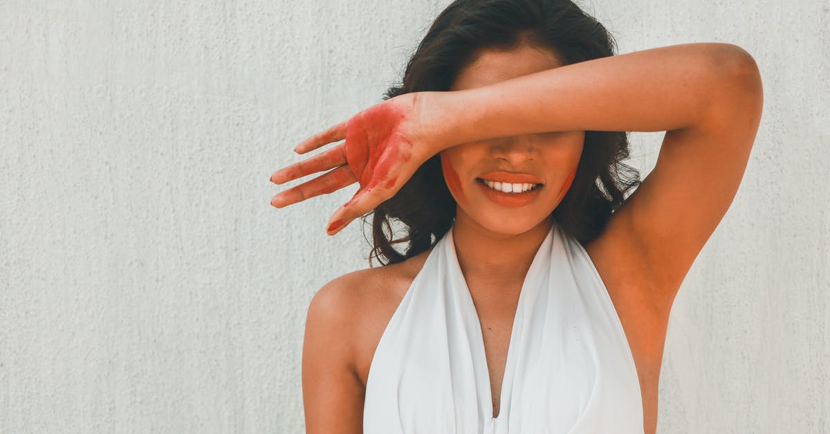 How to avoid getting arm hair in food? - Woman in White Halter Top Covering Eyes with Arm