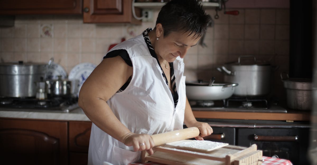 How to bake without an oven? [duplicate] - Woman in White Sleeveless Shirt Holding Brown Wooden Rolling Pin