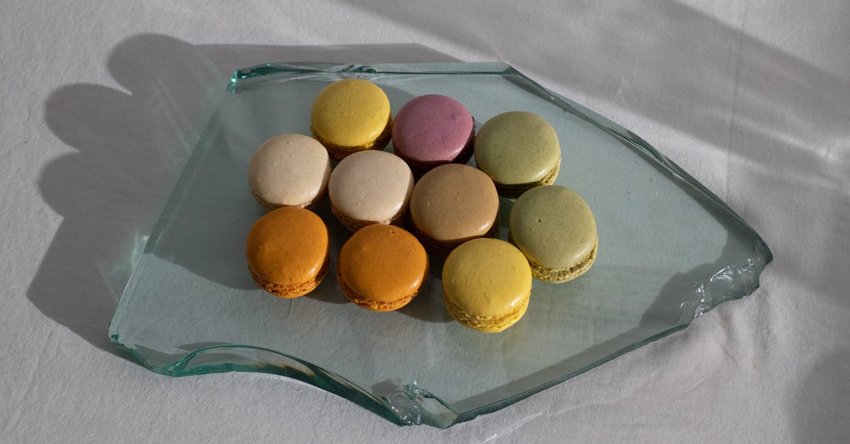 How to caramelize white sugar without burning it? - From above of broken piece of glass on white fabric with arrangement of delicious macaroons on top