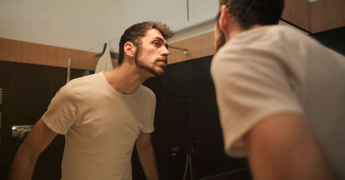 How to check freshness of paneer - Stylish concentrated man looking in mirror in bathroom