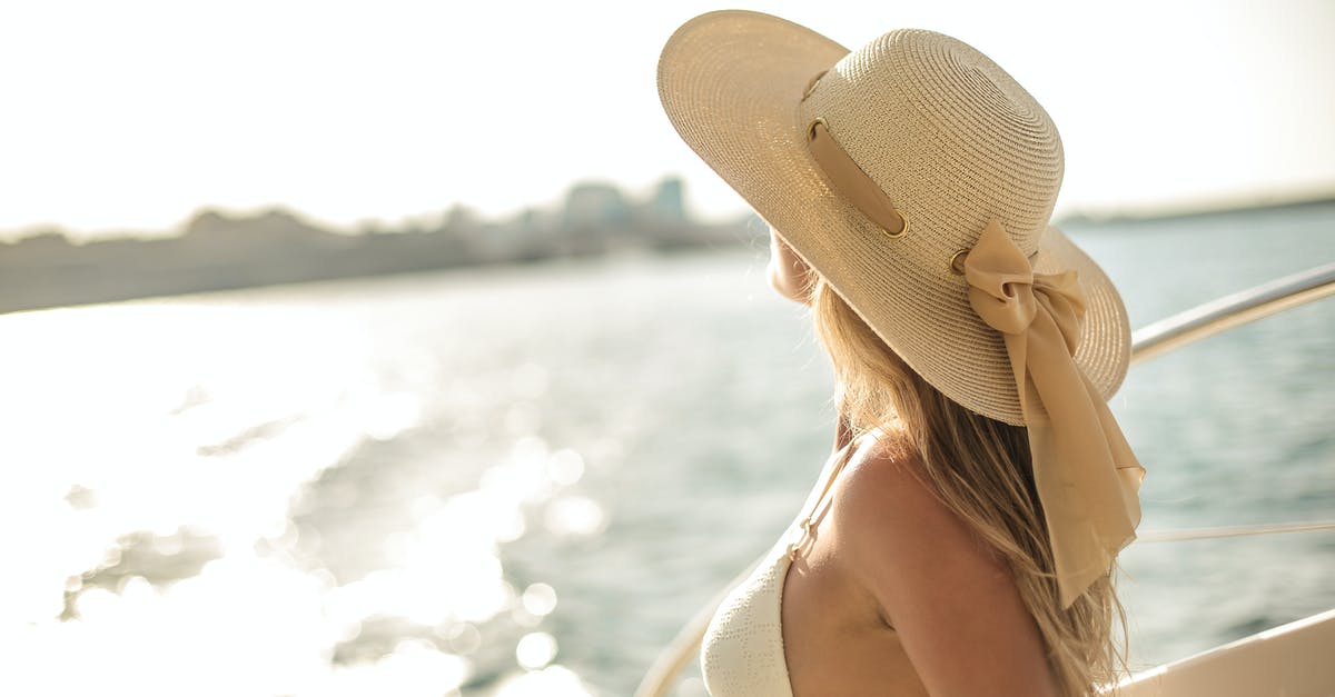 How to chill a compote? - Back view of slim female in bikini top and straw hat enjoying trip on cruise boat on sunny day while relaxing during summer vacation and looking away