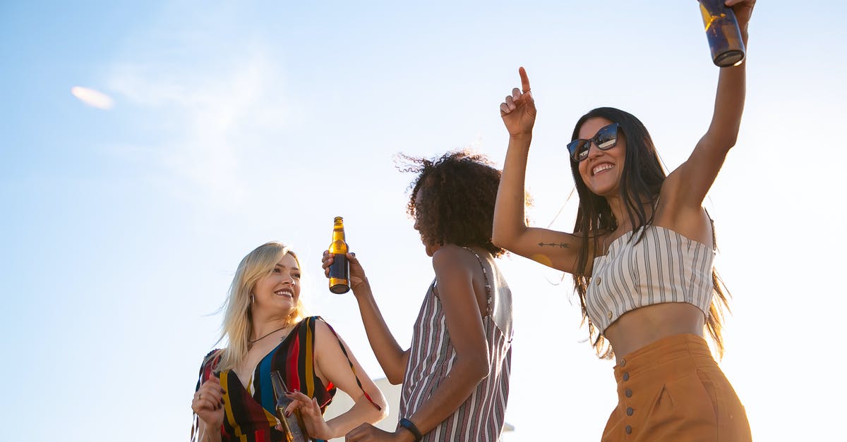 How to chill beer quickly? - Delighted friends having drinks and dancing on sunny terrace