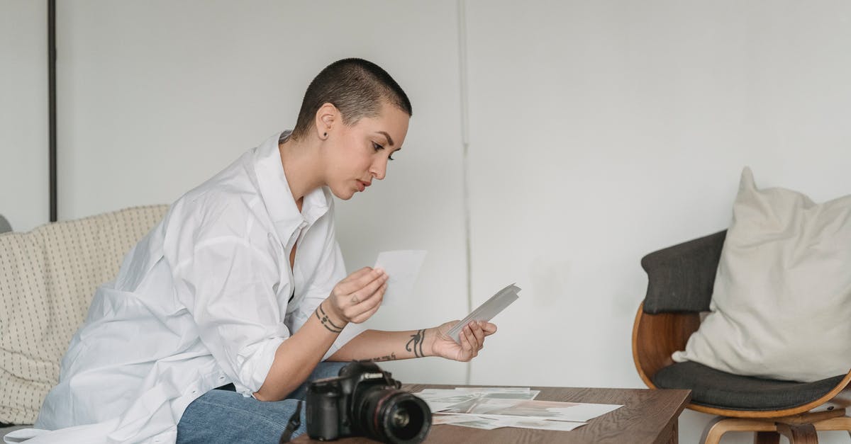 How to choose an upright, self-defrosting freezer? - Serious woman sitting at table and choosing photos