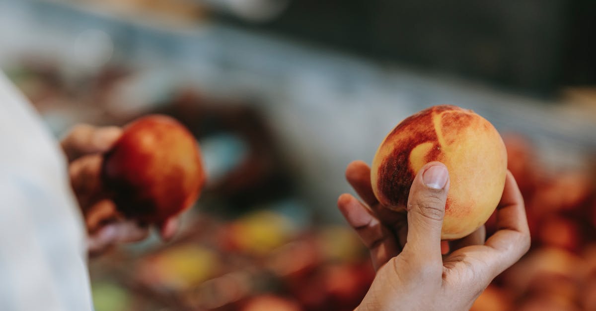 How to choose fresh, ripe (hot) jalapeños? - Crop faceless male choosing peaches in food market