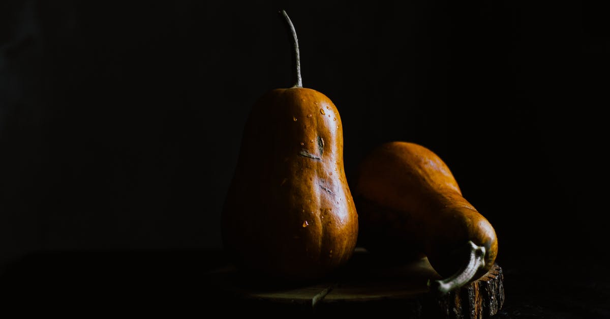 how to clean calabaza made of pumpkin - Pear shaped pumpkins on wooden board in darkness