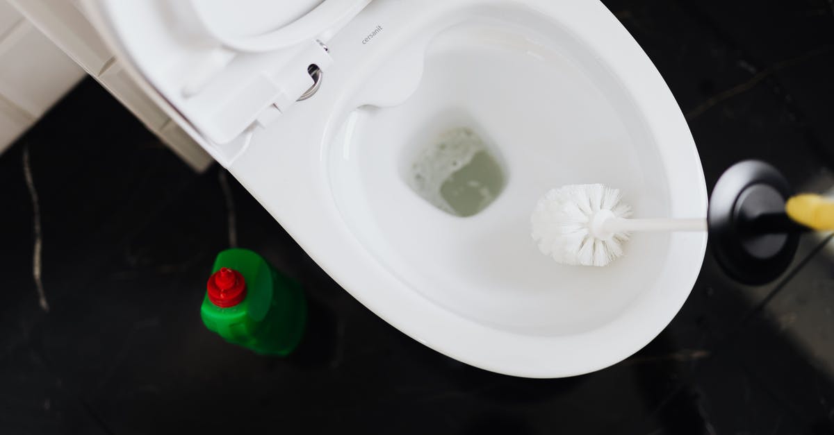 How to clean stains from anodized aluminum pans? - From above crop anonymous person in yellow gloves cleaning toilet bowl with toilet brush and liquid detergent in green plastic bottle