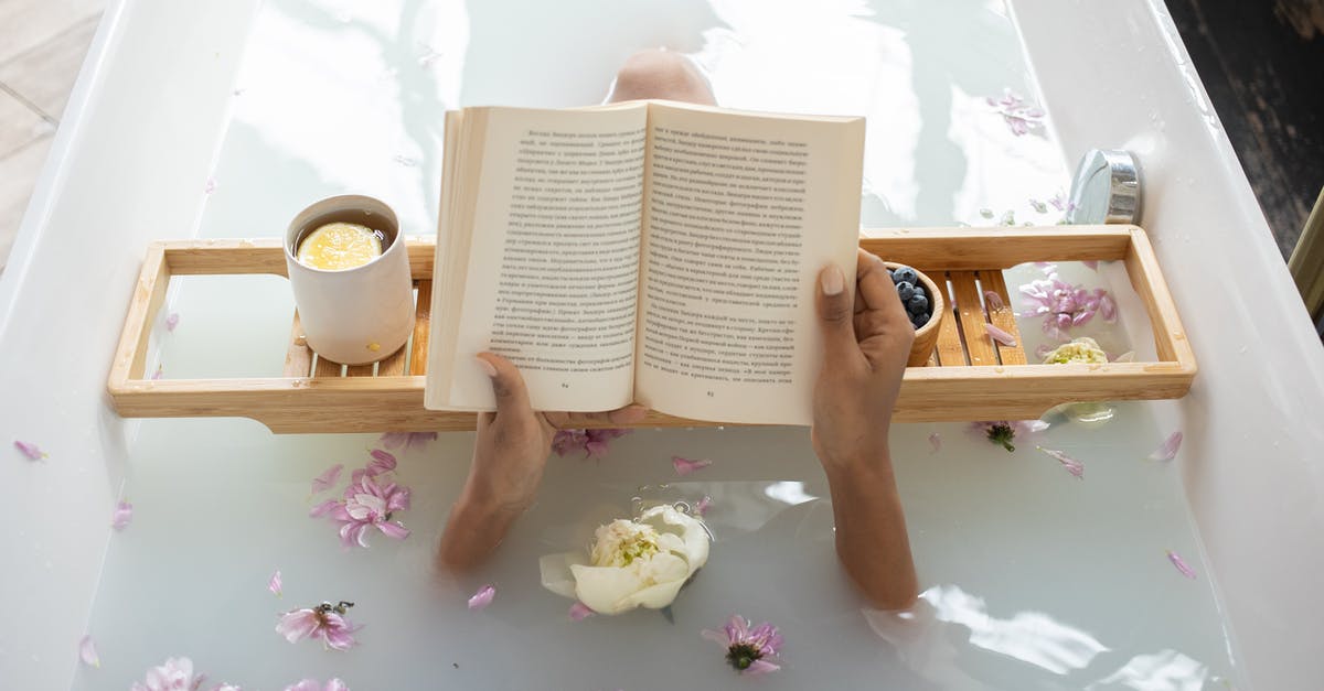 How to clean tea stains from a mug with steel interior? - Woman reading book while resting in bathtub