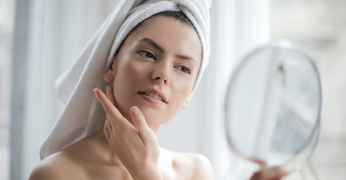 How to clean the rubbery skin from monkfish before cooking? - Selective Focus Portrait Photo of Woman With a Towel on Head Looking in the Mirror