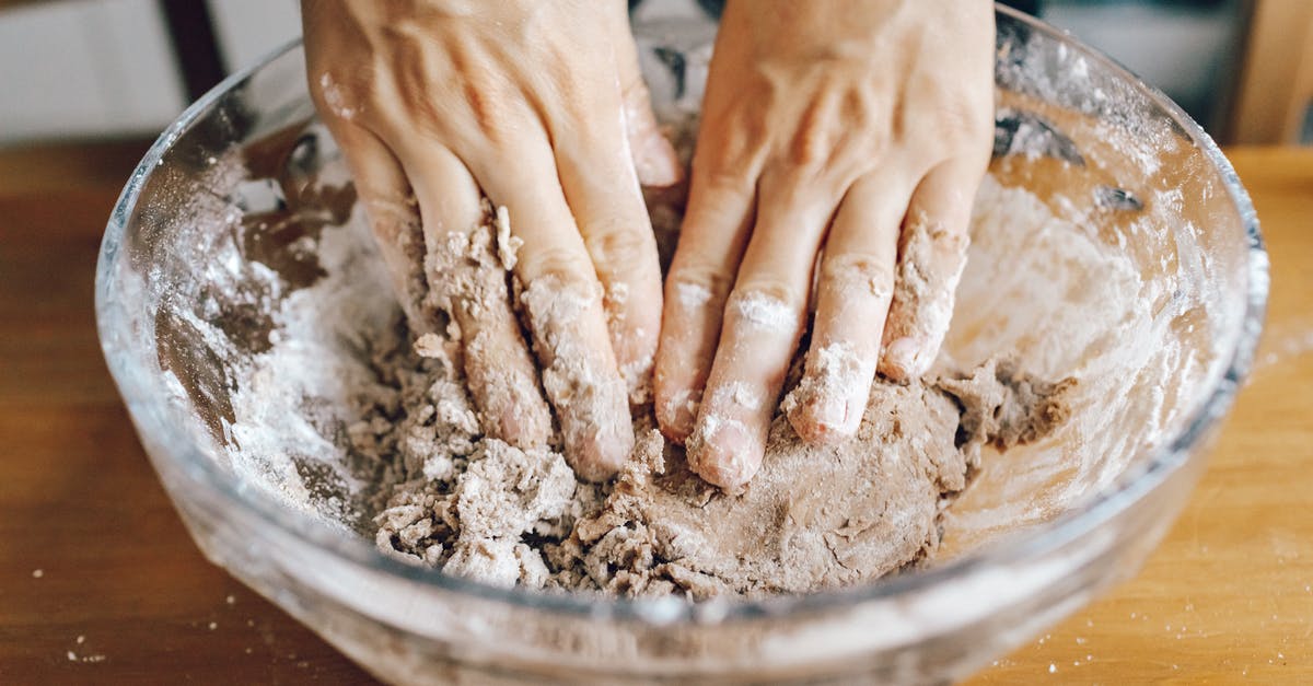 How to clean up after kneading dough? - Person Holding Brown Wooden Round Tray