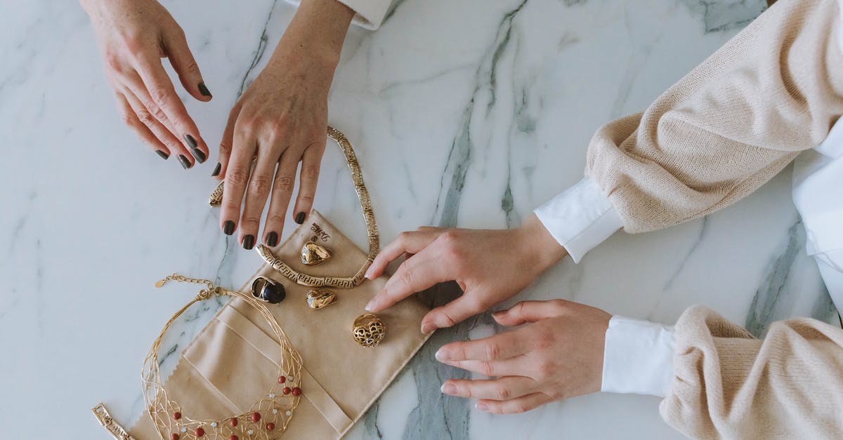 How to consistently get golden beads on meringue topping? - Two Women Touching Golden Jewelry on Marble Floor