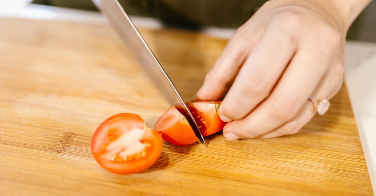 How to convert knife edge angle "ratios" into degrees? - Unrecognizable Female Hands Cutting Tomato into Pieces with Kitchen Knife