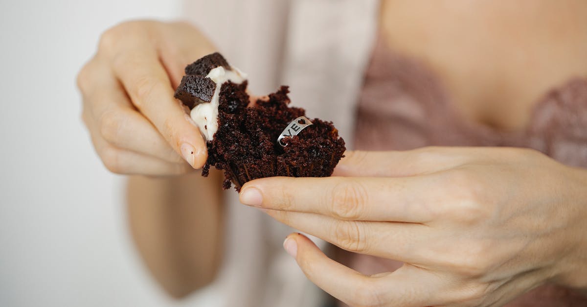 How to convert Ring Cake to Square Cake - Faceless woman showing ring inside chocolate cupcake