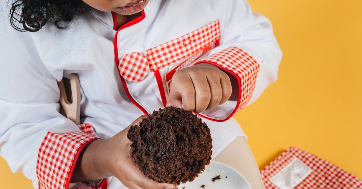 How to cook a tender quail? - From above of crop attentive African American girl in chef uniform preparing delicious chocolate treat above saucer