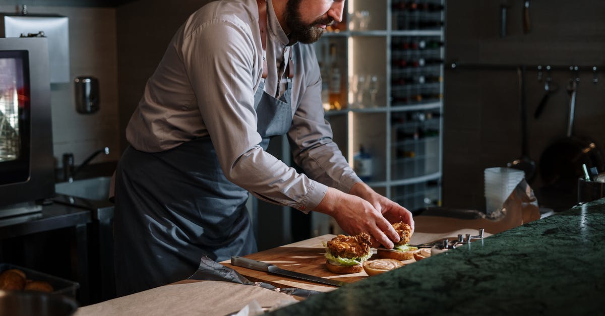 How to cook bison burgers (a.k.a. buffalo burgers)? - Man in White Dress Shirt Slicing Pizza