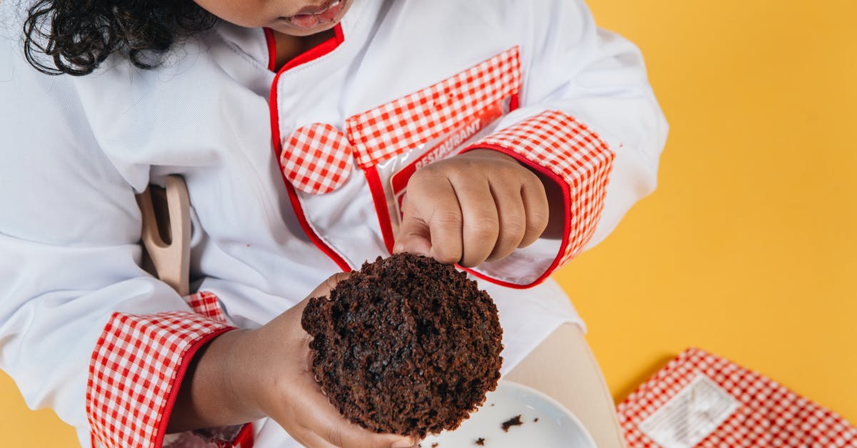 How to cook Brussells Sprouts and sweet potates in one oven? - From above of crop attentive African American girl in chef uniform preparing delicious chocolate treat above saucer