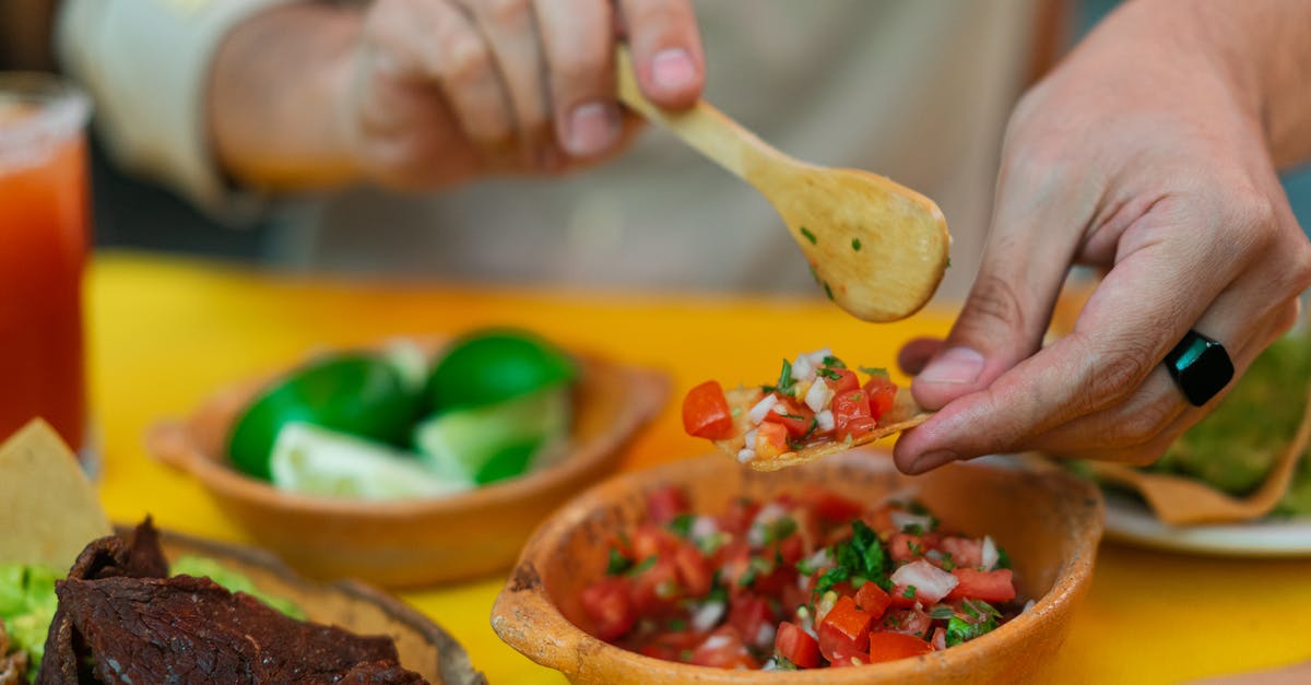 How to correct bitterness in blended homemade salsa? - Person Holding Brown Wooden Spoon