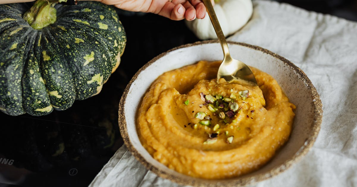 How to correctly infuse cream into vegetables - Hand Holding Spoon in Bowl with Food