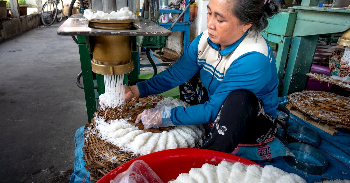 How to create the best veg noodles? - Ethnic lady making noodle on machine in factory