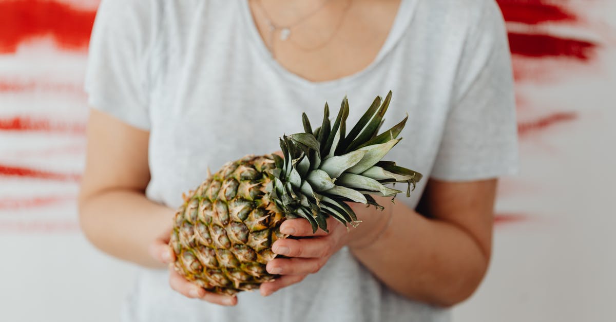 How to deal with a fresh hare? - Woman in Gray Crew Neck T-shirt Holding Pineapple