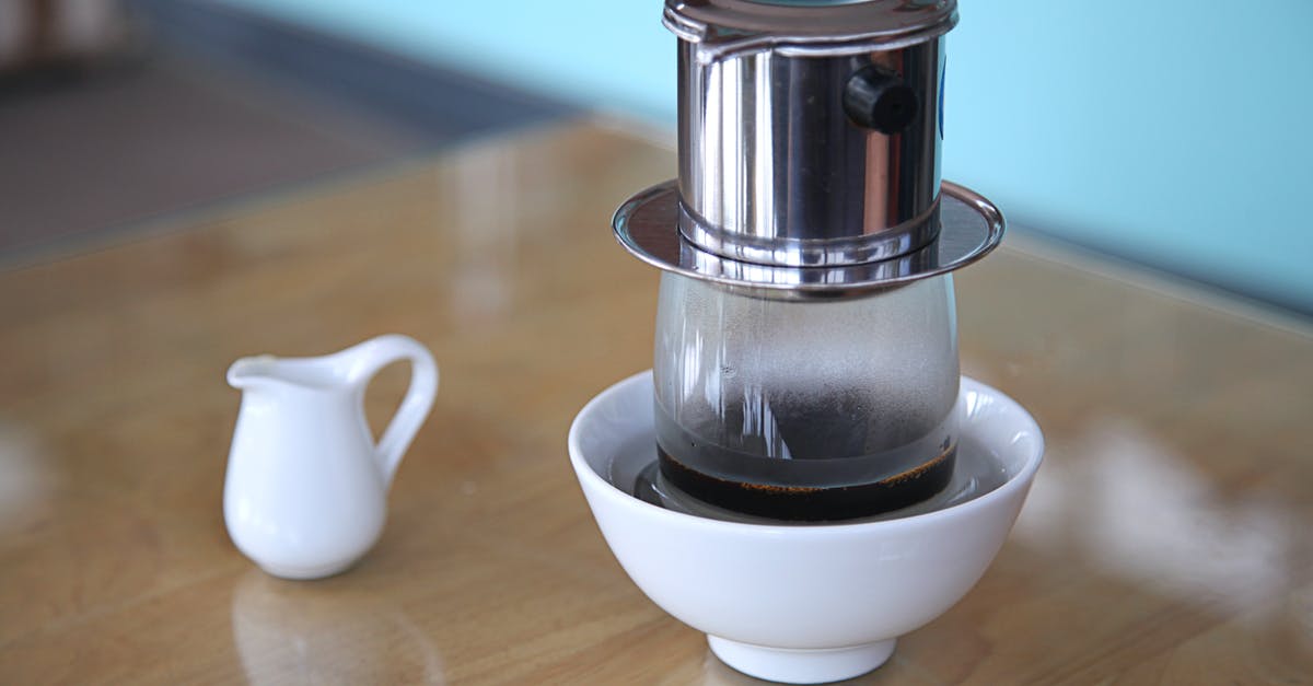 How to declog coffee maker clogged by milk - Vietnamese coffee maker on ceramic bowl placed on table