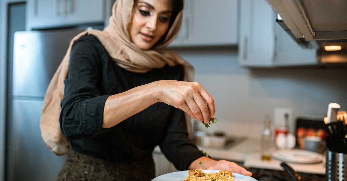 How to defrost coriander / cilantro? - A Woman Garnishing Her Rice and Meatballs Dish