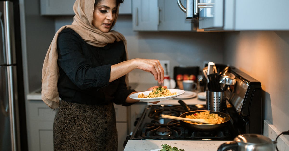 How to defrost coriander / cilantro? - A Woman Garnishing Her Rice and Meatballs Dish