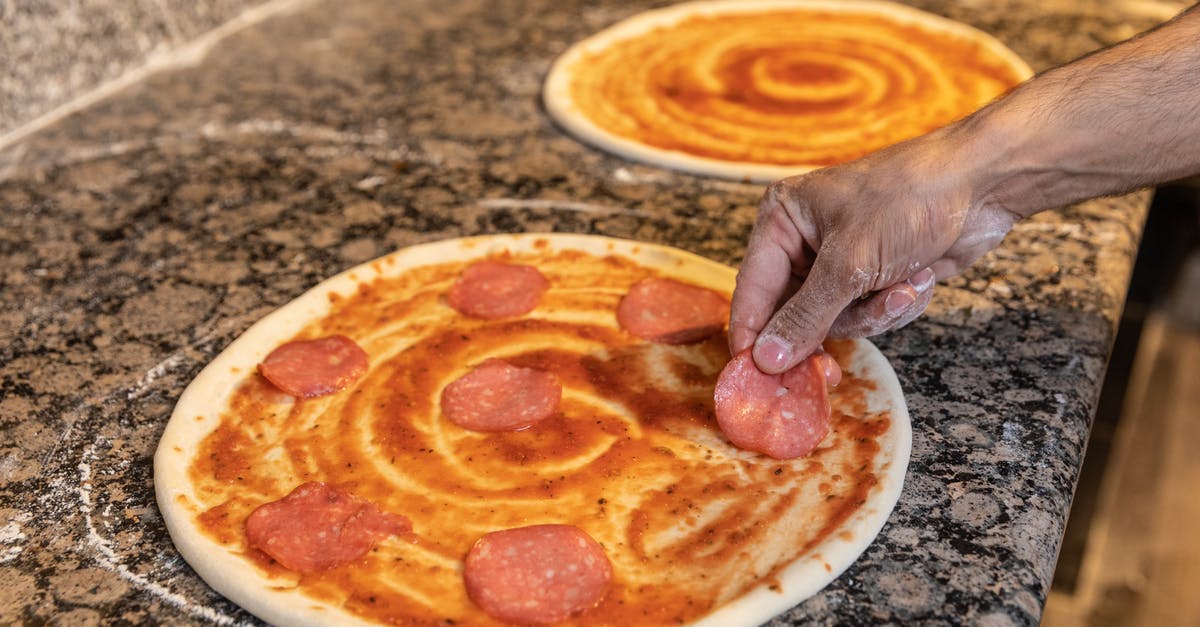 How to defrost frozen pizza dough quickly? - Person Holding Pizza on White Ceramic Plate