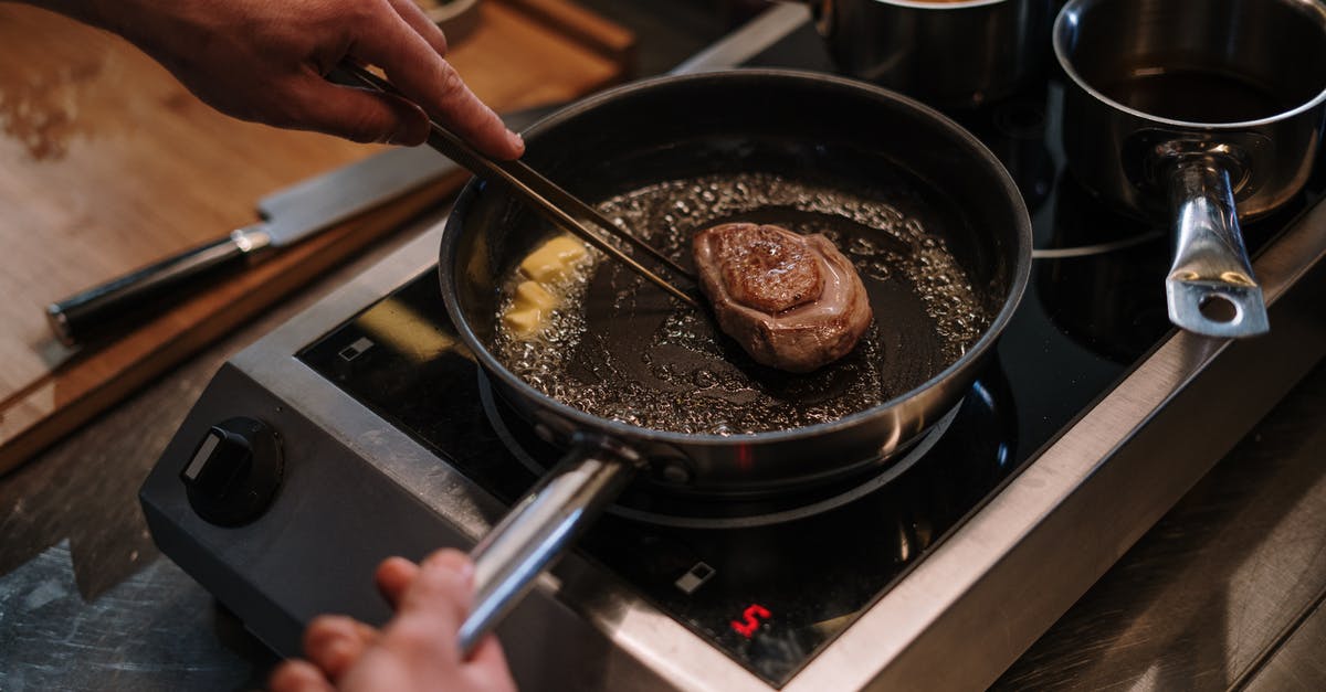 How to determine perfect pan temperature for steak? - Person Cooking on Black Frying Pan