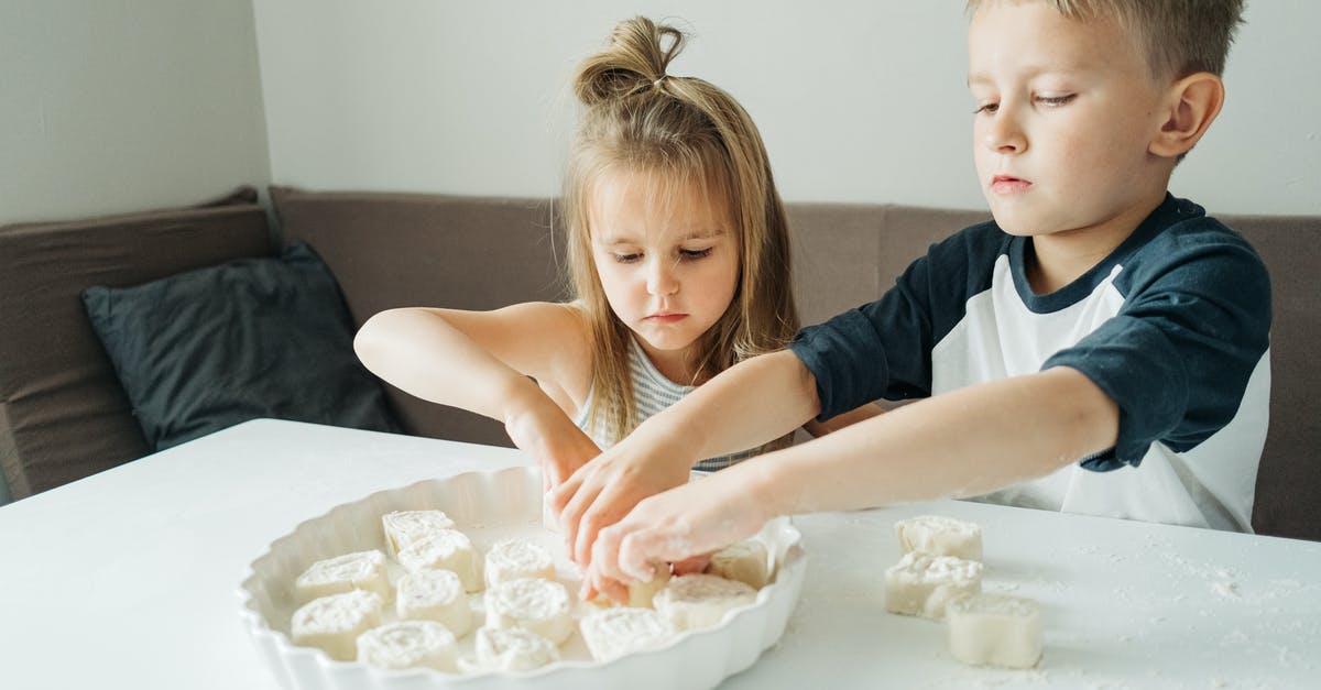 How to find/properly cook fresh Baby Squids? - Girl in Blue and White Shirt Sitting Beside Girl in White Shirt