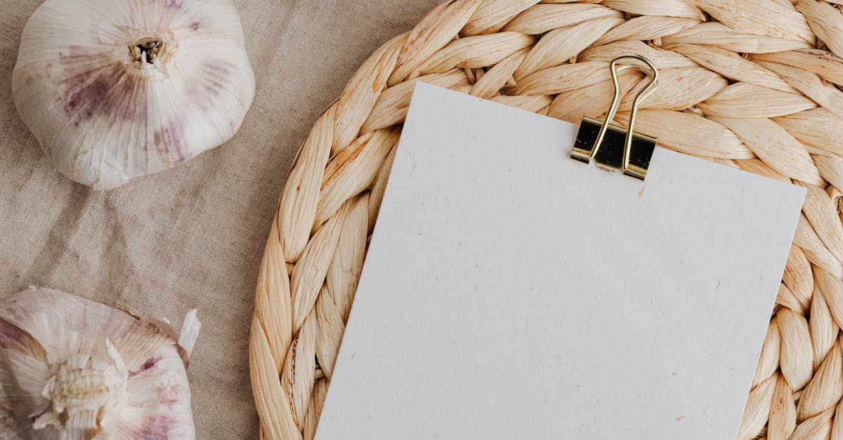 How to fix food that got extra salty? - Sheet of white empty paper fixed with clip near garlic