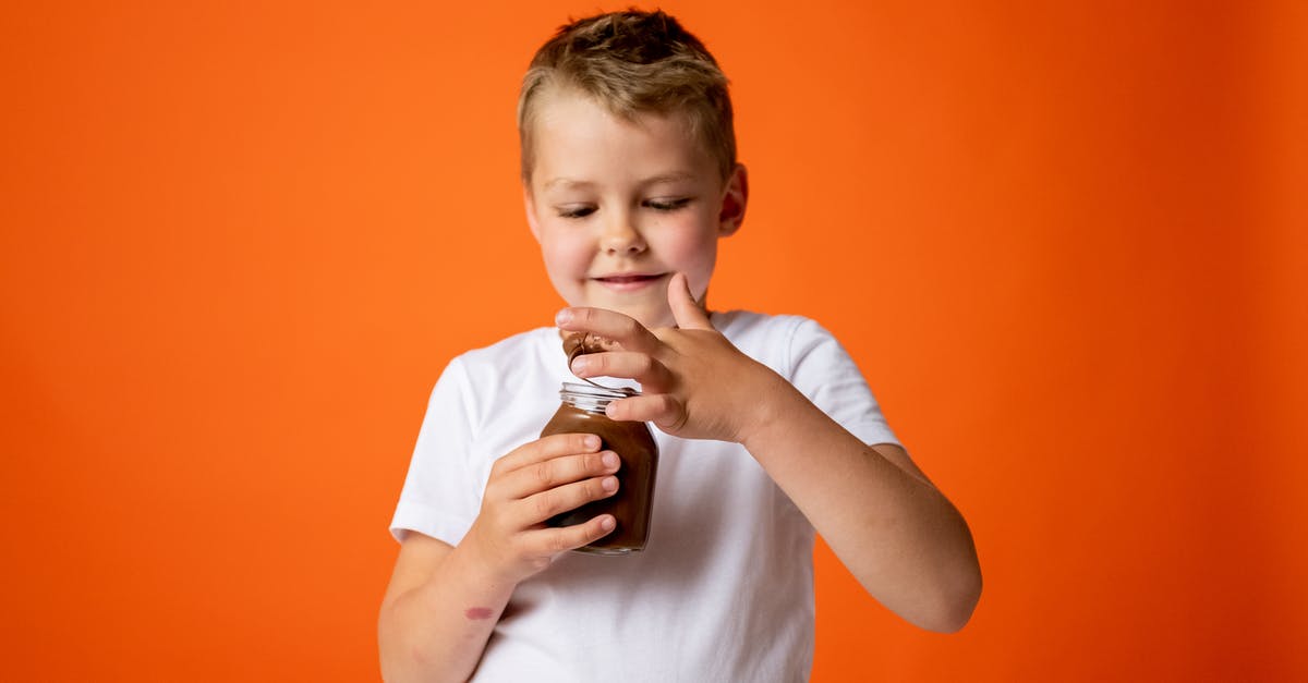 How to fix oily modeling chocolate - Boy in White Crew Neck T-shirt Holding Chocolate Jar