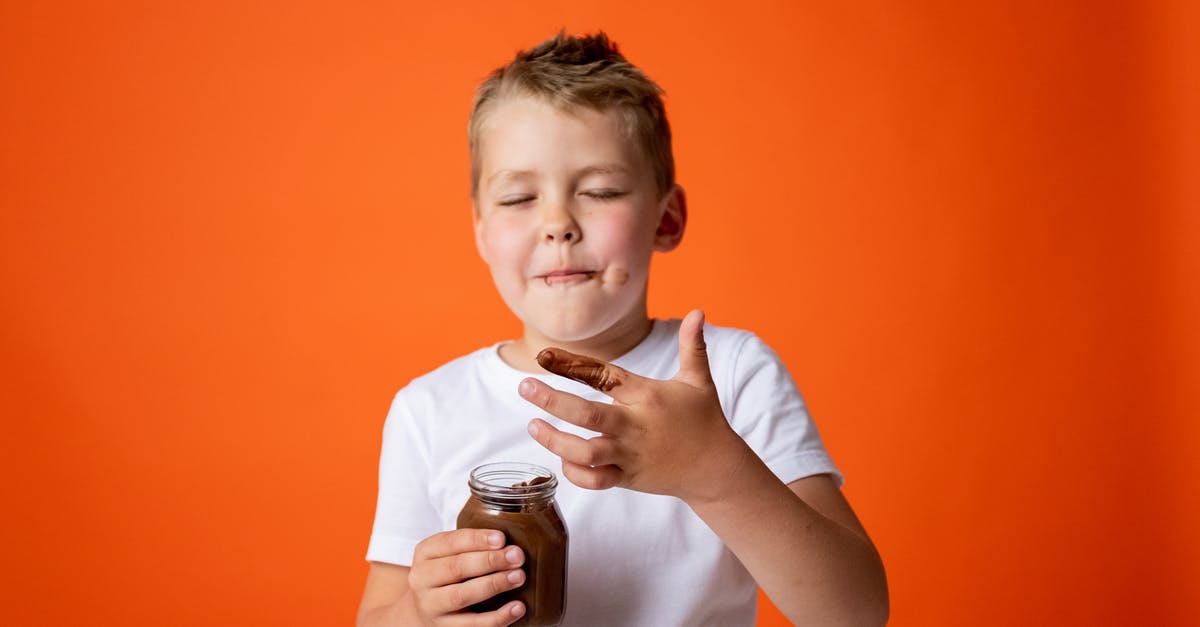 How to fix oily modeling chocolate - Boy in White Crew Neck T-shirt Holding Chocolate Jar