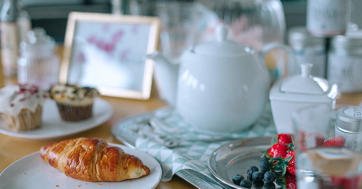 How to fix the consistency of blueberry jam? - Appetizing croissant and muffins served on table with teapot and berries