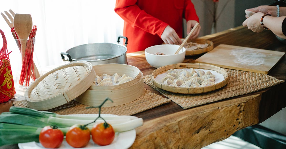 How to fold camembert in dough - Unrecognizable women cooking Asian dumplings with meat and veggies in kitchen