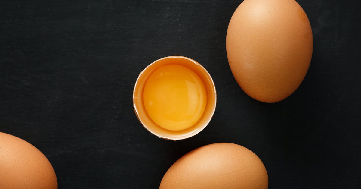 how to freeze individual chicken pot pies - Top view of whole and half of fresh chicken eggs with yolk representing uniqueness concept