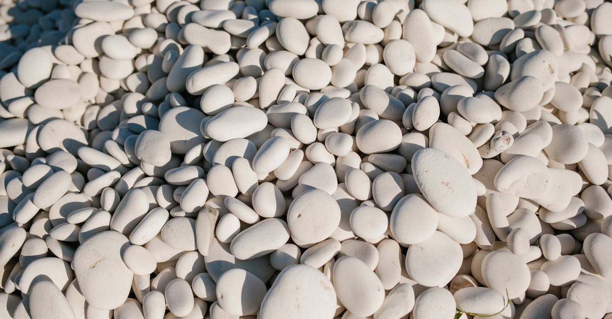 How to get a smooth paste from ground chickpeas? - From above of white small smooth and round stones in pile at sunshine