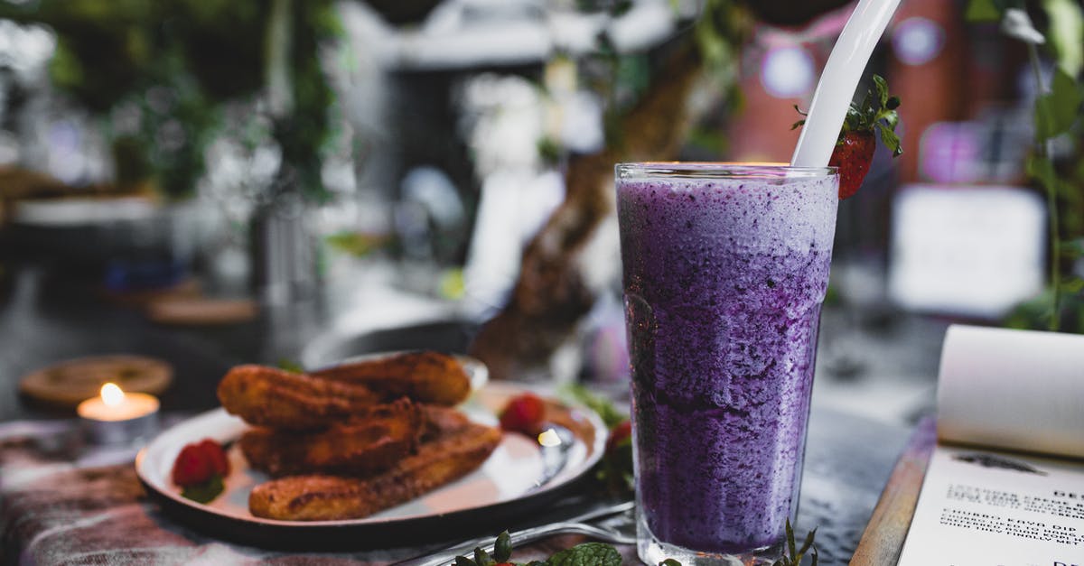 How to get raspberry flavor into a smoothie without seeds? - Delicious churros with fresh strawberries and blueberry smoothie in cafe