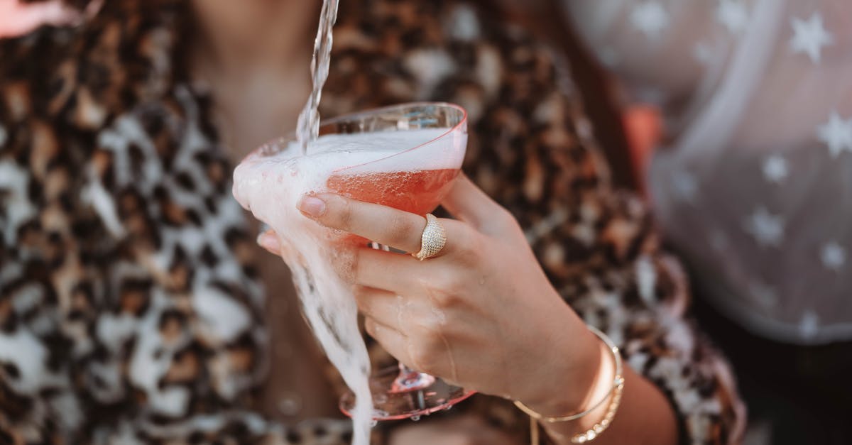 How to get rid of foam on shaken cocktails - Woman Holding Clear Drinking Glass With Red Liquid