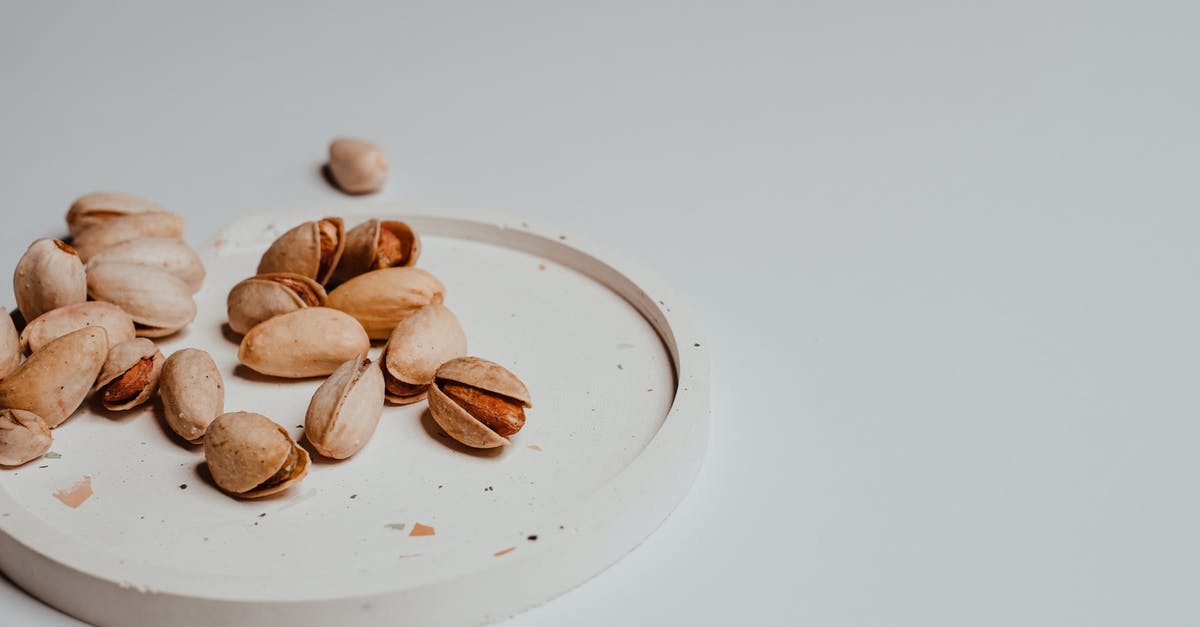 how to grind pistachio nuts so that they stay dry - Pistachios on White Ceramic Coaster