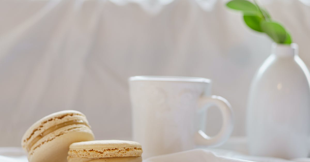 How to keep a cheesecake layer seperate from filling during baking? - Delicious macaroons near mug and vase with green plant