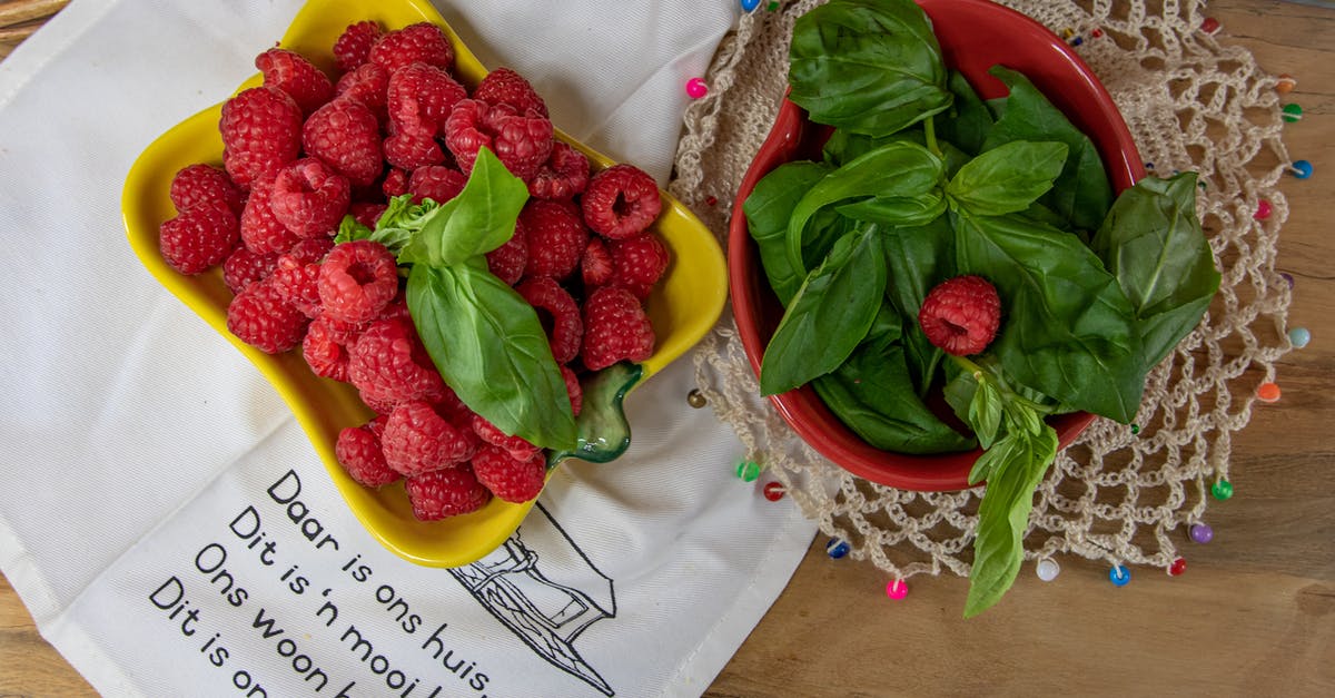 How to keep basil leaves from turning black? [duplicate] - Overhead Shot of Raspberries and a Bowl of Basil Leaves