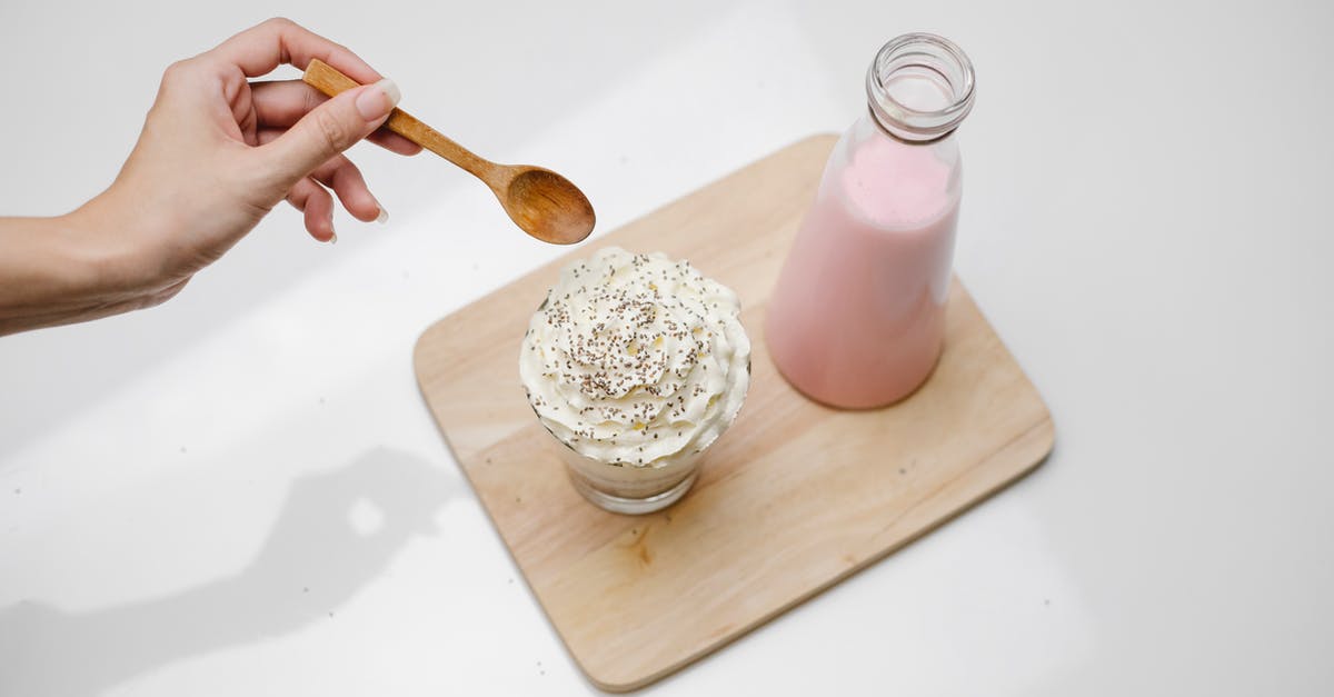 How to keep cream from separating in milk? - Woman checking dessert with whipped cream in studio