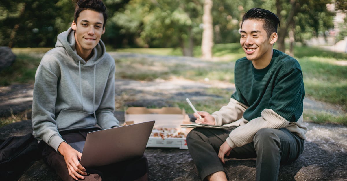 How to keep my pizza stone from smoking? - Cheerful multiethnic students working on project together