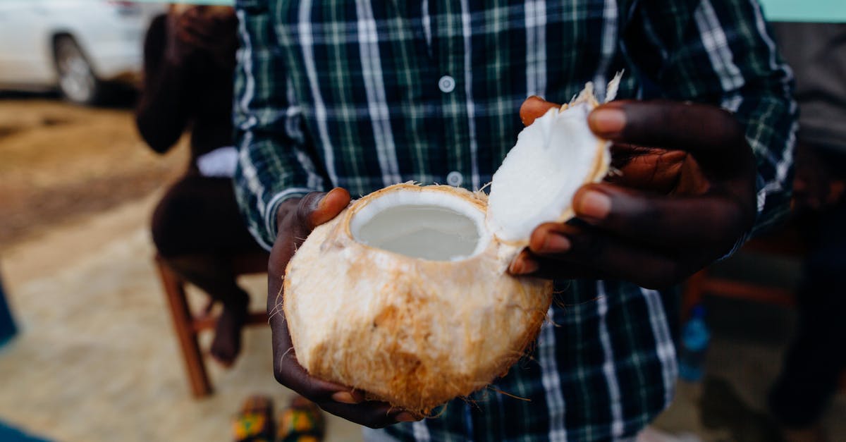 How to keep opened coconut safely? - Person Holding Open Coconut Fruit